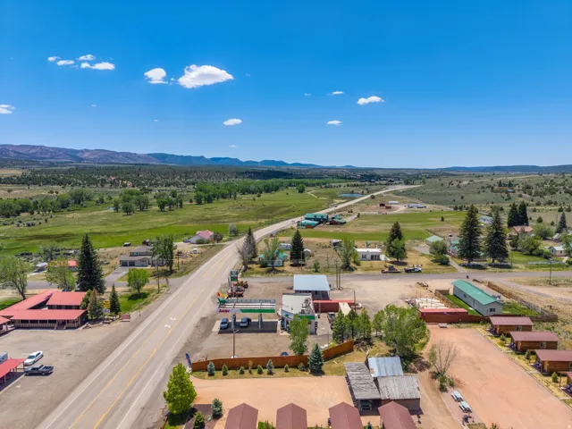 Aerial perspective showcasing a multi-building property with a paved road