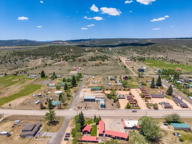 Aerial perspective showcasing multiple commercial and residential structures, extensive land, and established roadways