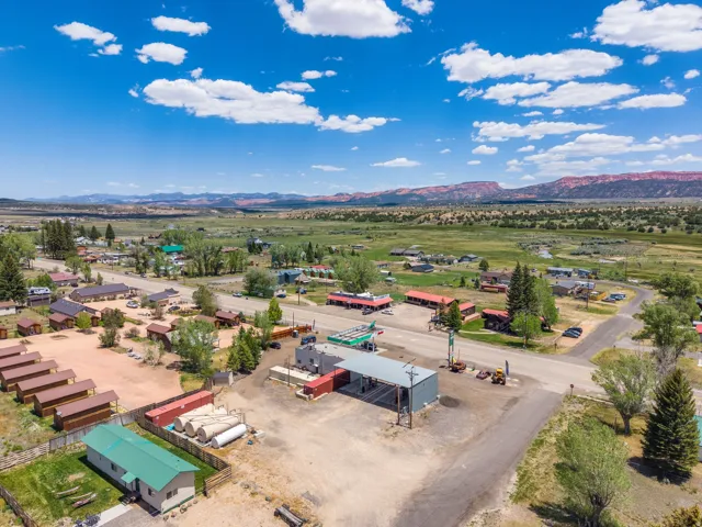 Aerial perspective showcasing a community with numerous structures along a roadway