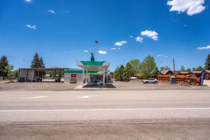 Roadside commercial property featuring a gas station with multiple pumps and a covered service area