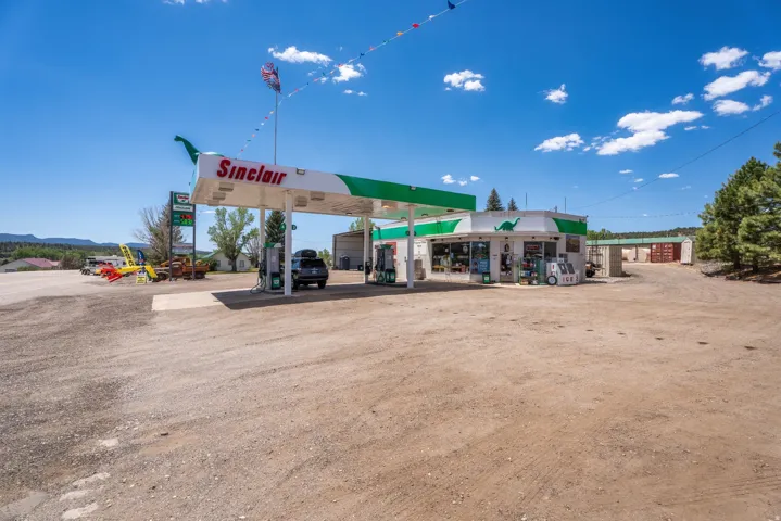 Sinclair branded gas station and convenience store with multiple fuel pumps under a canopy