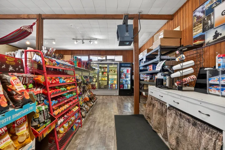 Retail interior featuring wood-finish flooring, white panel ceiling, and recessed lighting