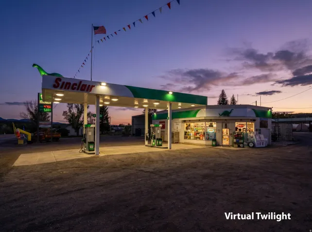Sinclair gas station with a prominent canopy, multiple fuel pumps, and a visible convenience store