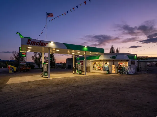 Commercial property featuring a gas station canopy with multiple fuel pumps and an attached convenience store