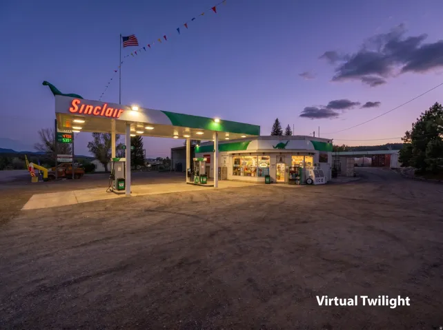 Commercial gas station property with a large, illuminated Sinclair sign