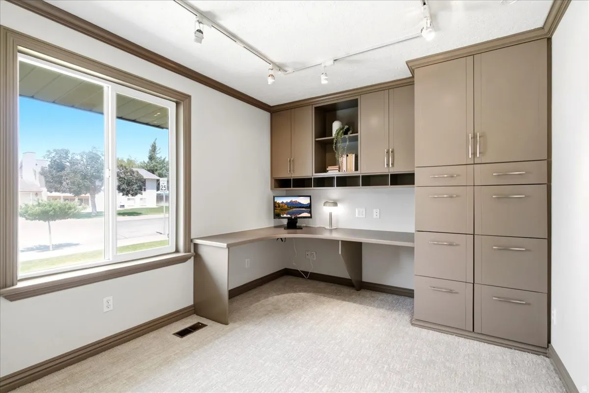 Built-in desk and cabinetry featuring ample storage options