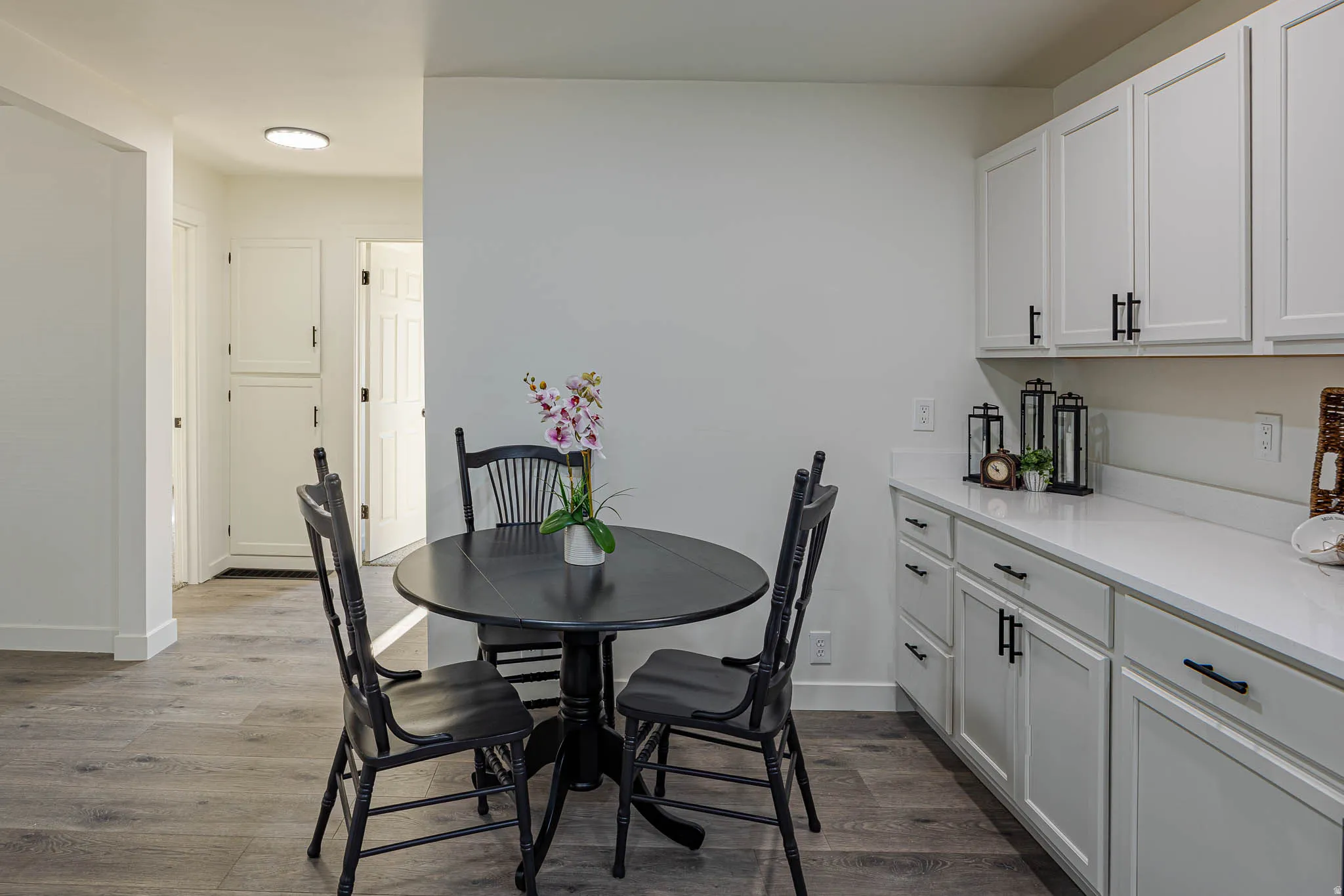 Wood-finish flooring throughout, complemented by white walls