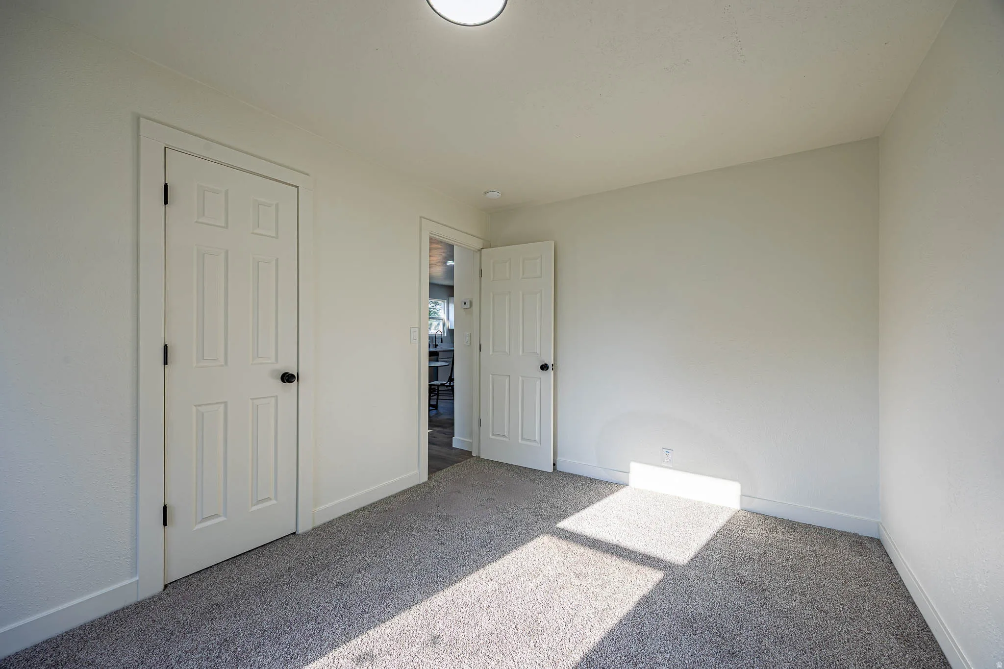 Neutral-toned carpeting paired with white walls