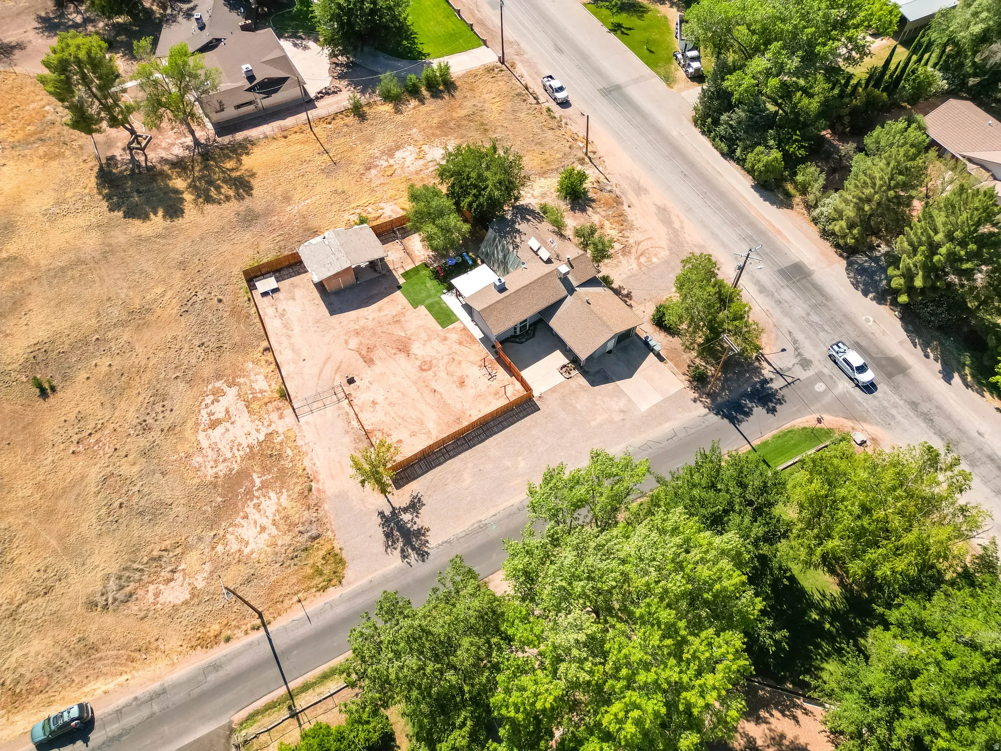 Aerial property view featuring a single-story residence with an attached garage and a covered patio area