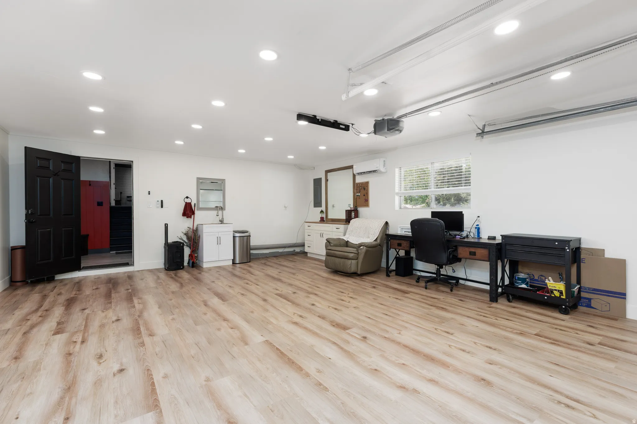 Spacious interior featuring wood-finish flooring, recessed lighting, and white walls