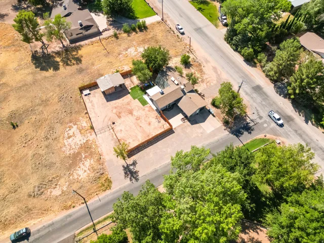 Aerial property view featuring a single-story residence with an attached garage and a covered patio area