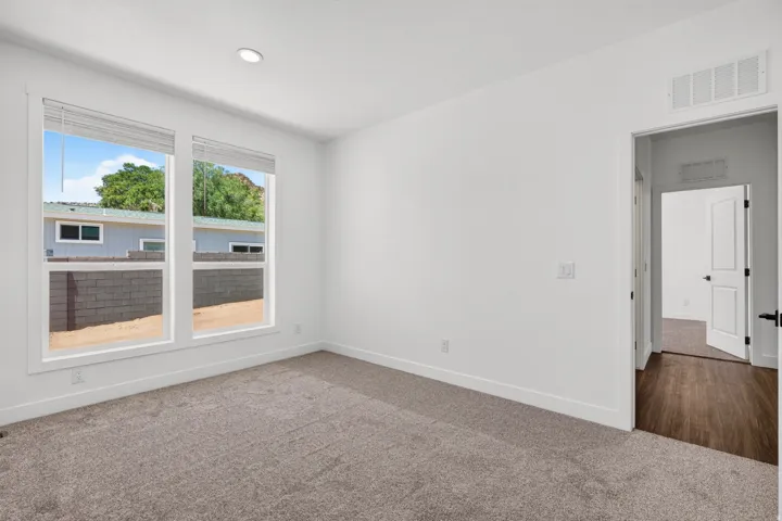 Bright interior space with dual windows and neutral carpeting