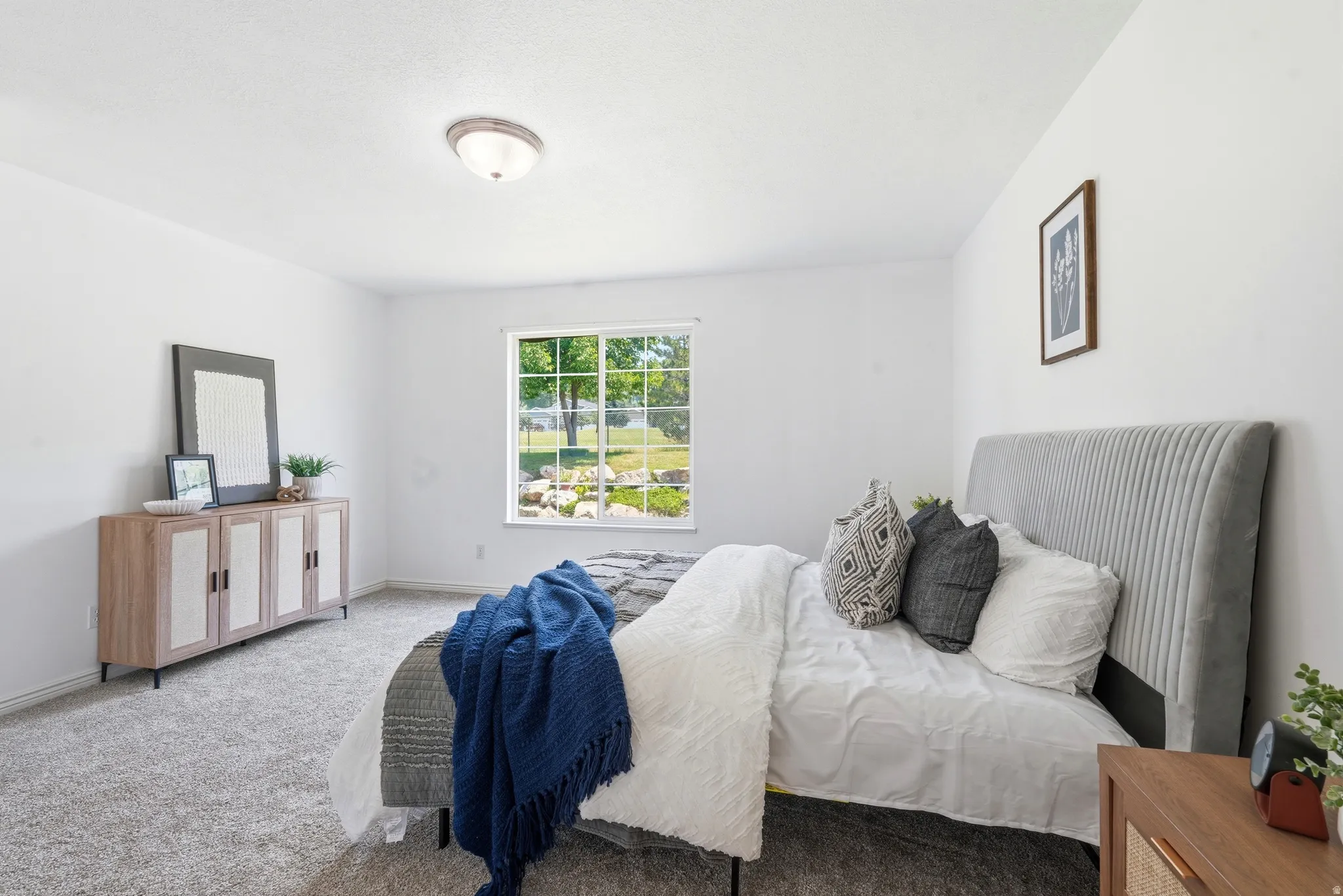 Bright room featuring neutral wall paint and carpet flooring
