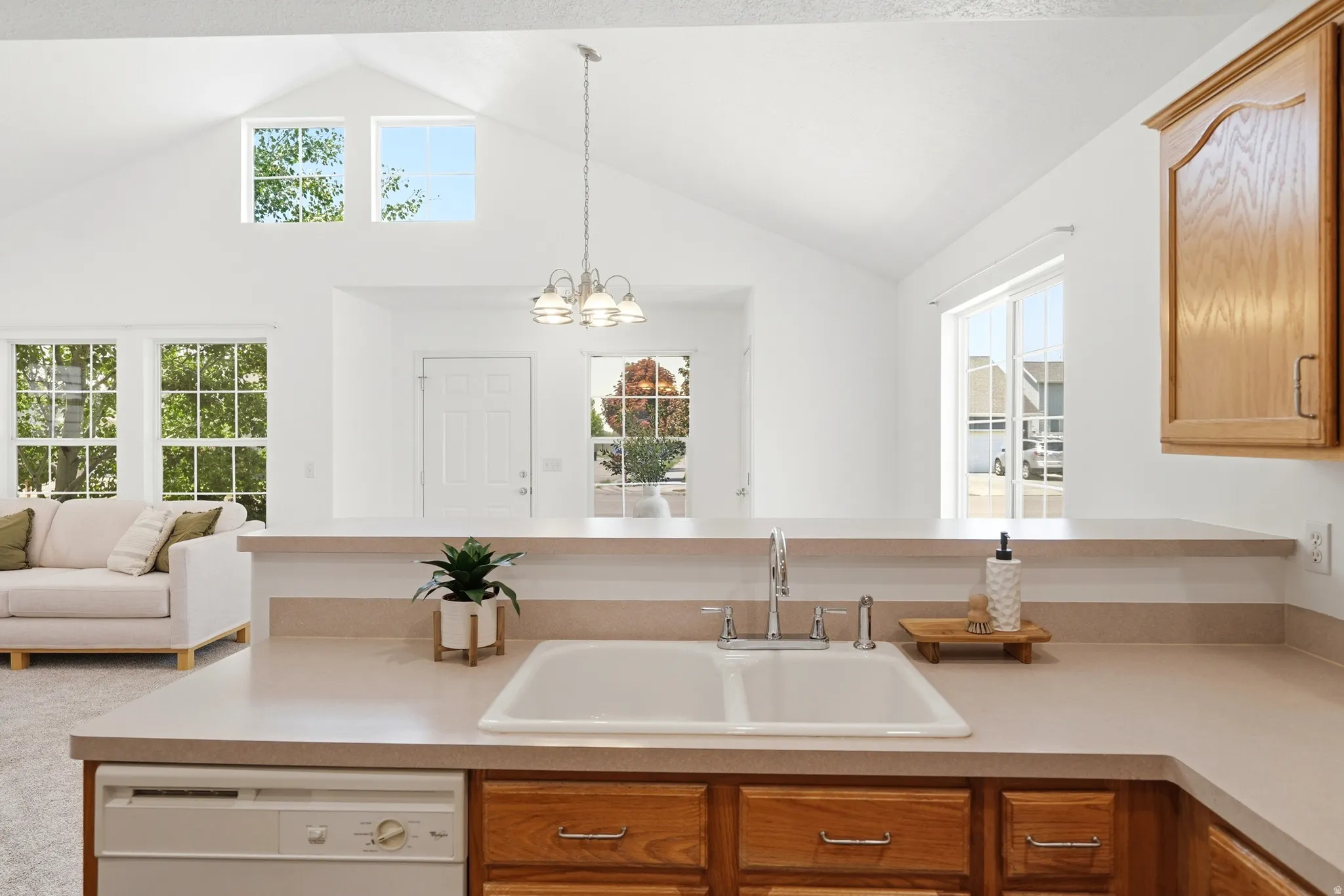 Spacious kitchen featuring a double basin sink, ample counter space, and wood cabinetry