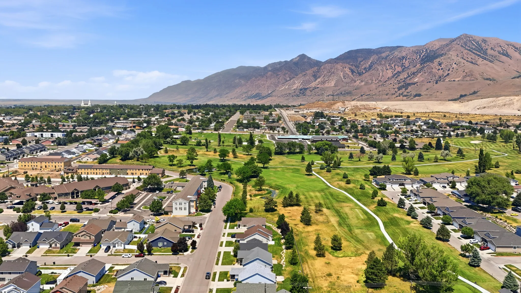 Aerial perspective showcasing a residential community against a mountain backdrop