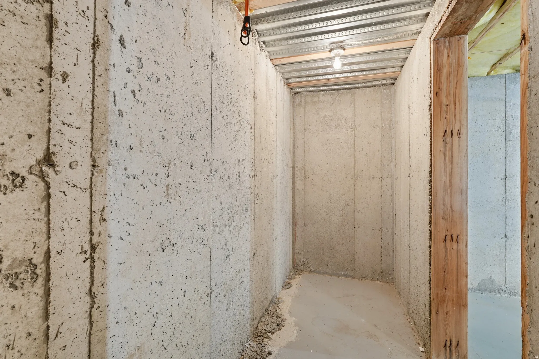 Unfinished basement area featuring concrete walls and flooring
