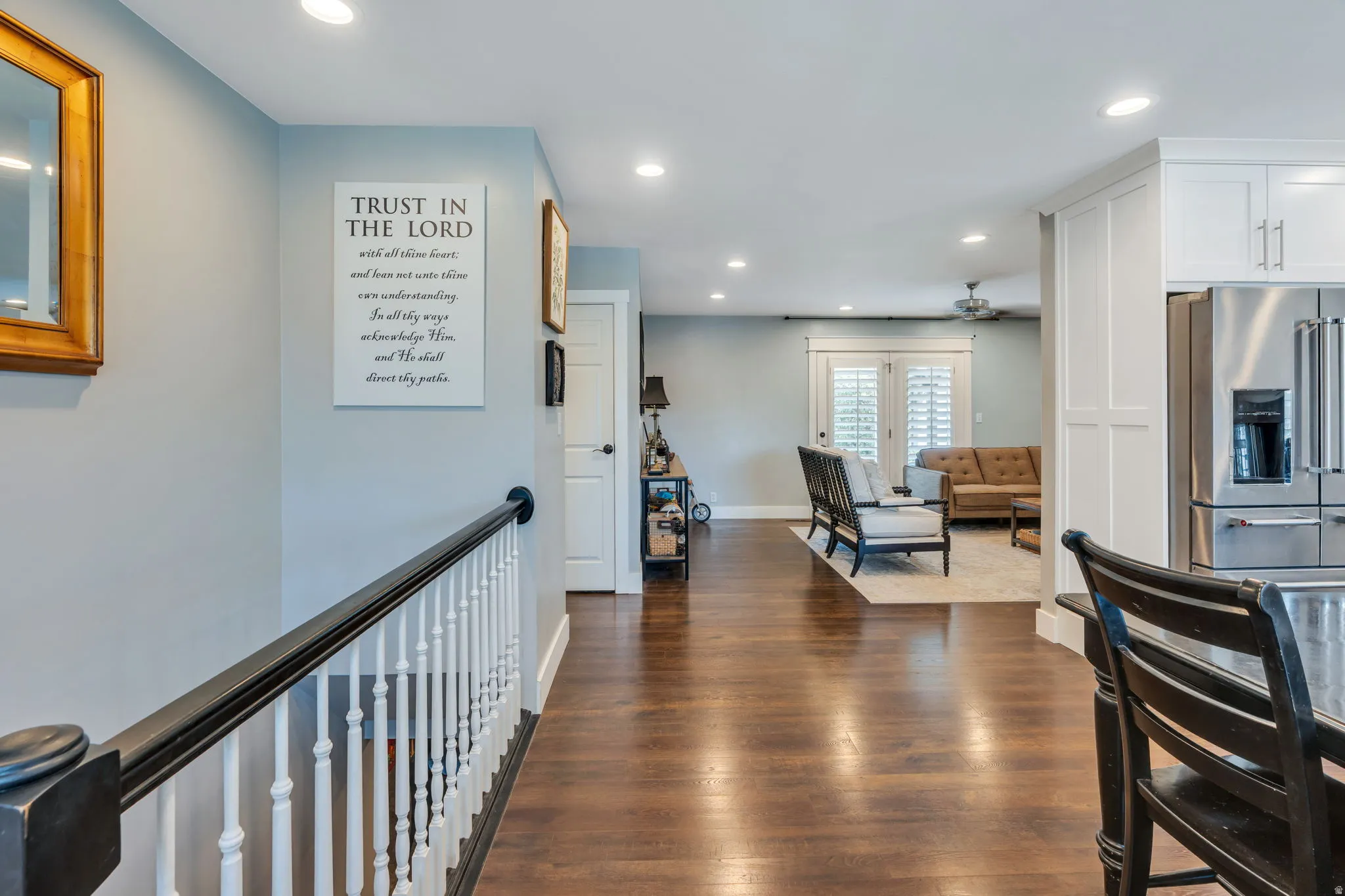 Open-concept living area featuring rich wood-finish flooring throughout