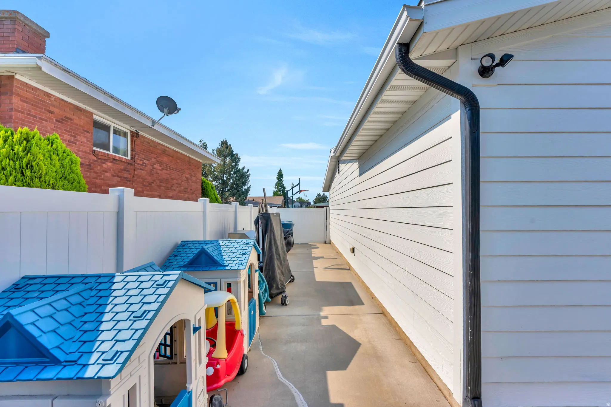 Side yard featuring a concrete pathway.