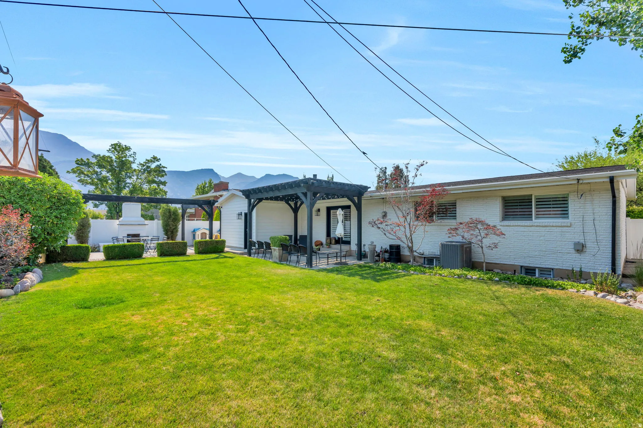 Expansive green lawn with a white brick exterior