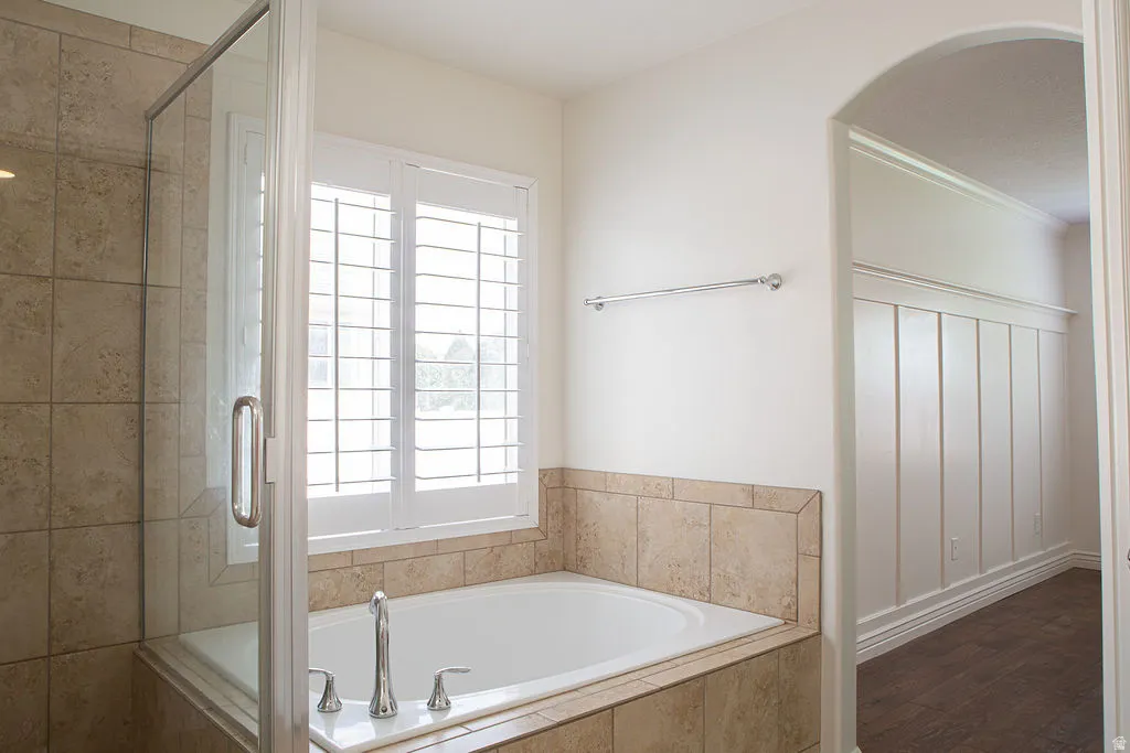 Recessed tub featuring tile surround and polished chrome fixtures