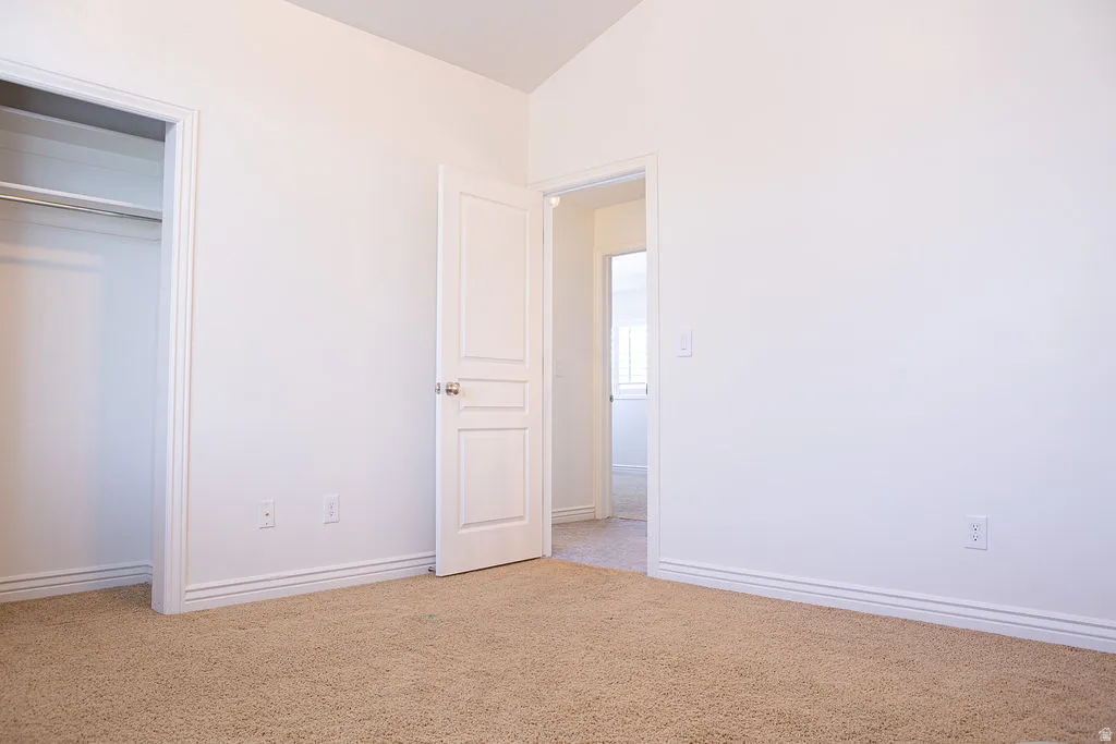Neutral tone interior featuring plush carpet flooring