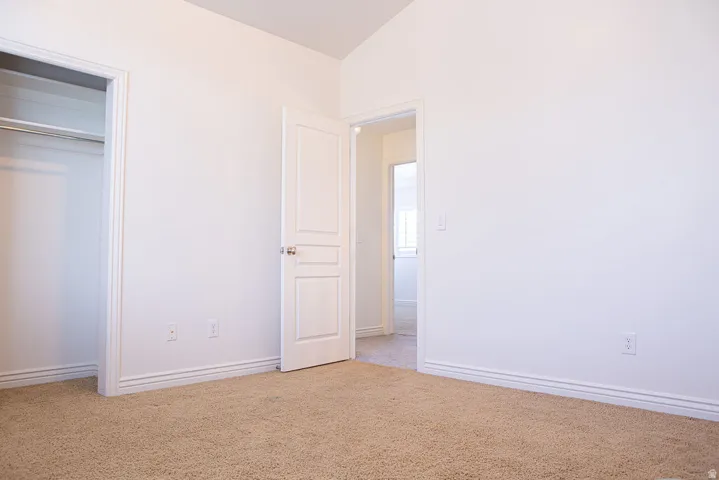 Neutral tone interior featuring plush carpet flooring