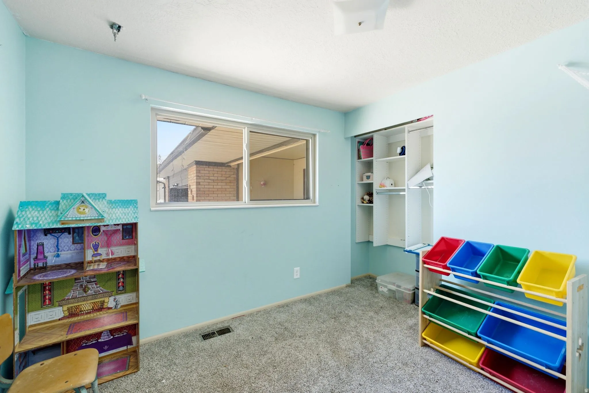 Room featuring a double-pane window, wall-to-wall carpeting, and a built-in closet with shelving