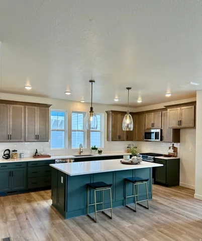Modern kitchen with a central island featuring a white countertop and seating for two