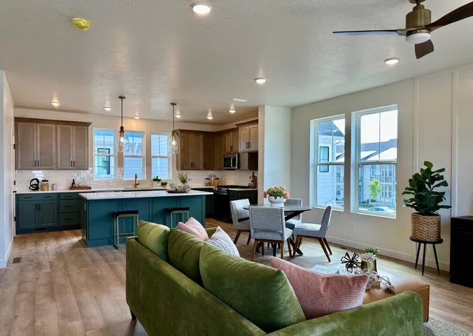 Open-concept living area featuring wood-finish flooring, recessed lighting, and a ceiling fan