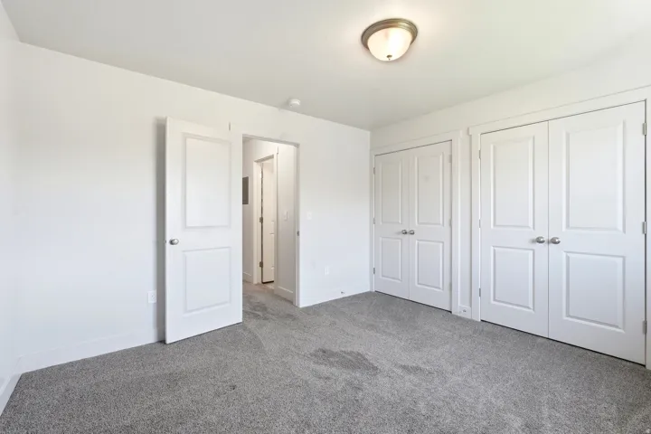 Room featuring grey carpeting, white painted walls, and a semi-flush mount ceiling light fixture