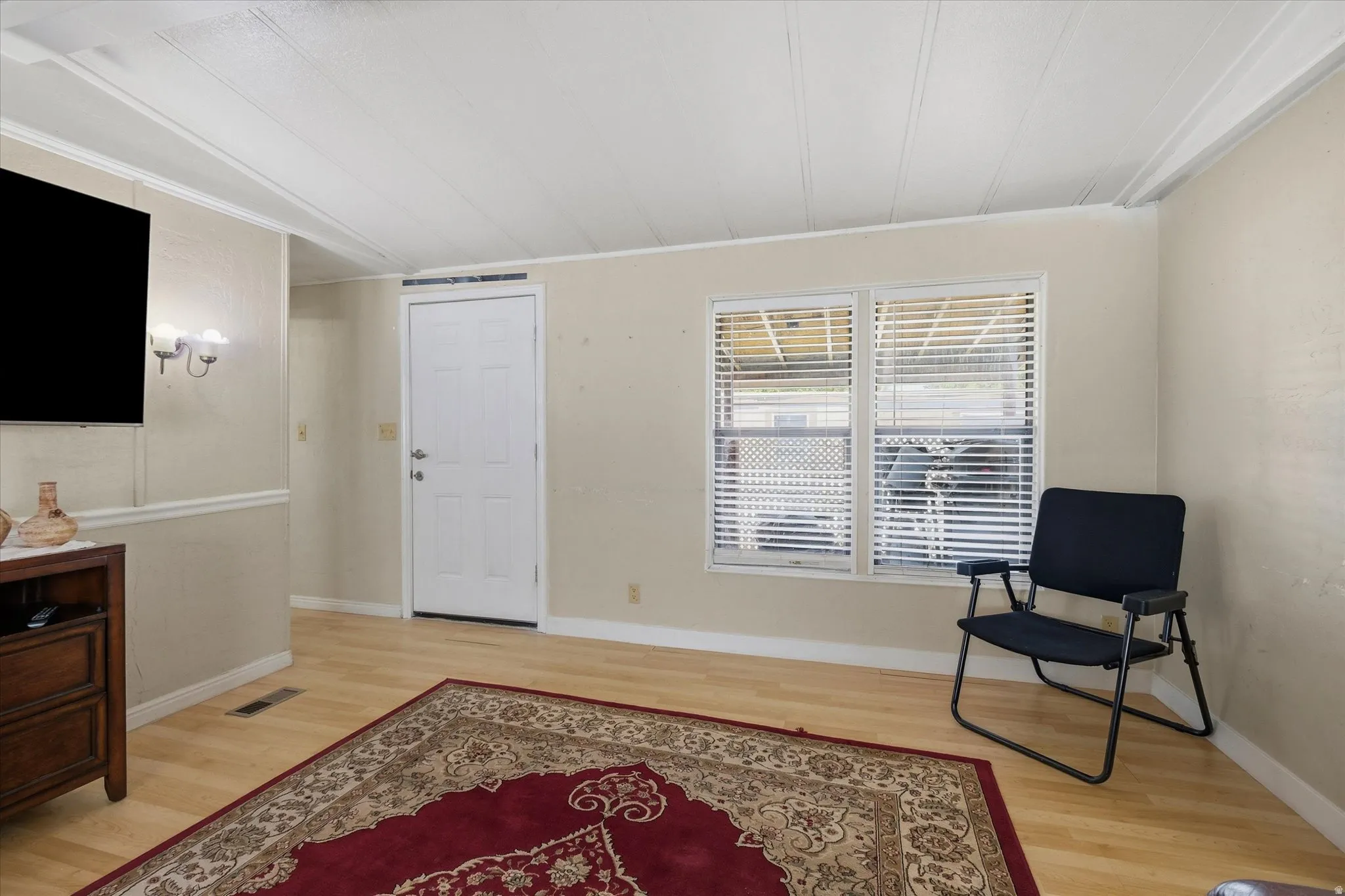 Interior space featuring light wood-finish flooring, neutral-toned walls, and white trim
