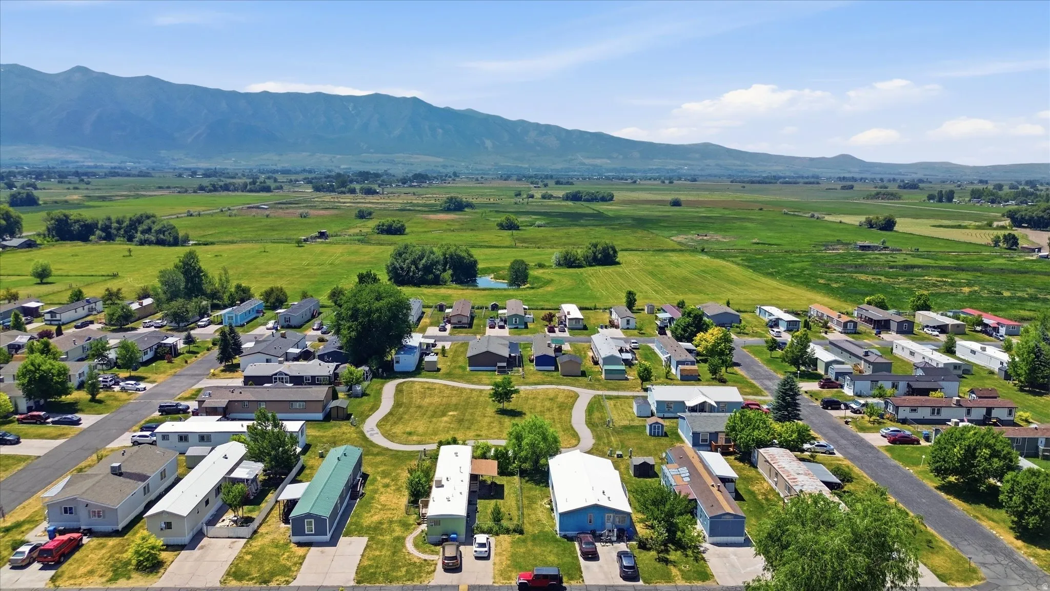 Expansive residential community featuring individual homes, paved roadways, and landscaped green spaces