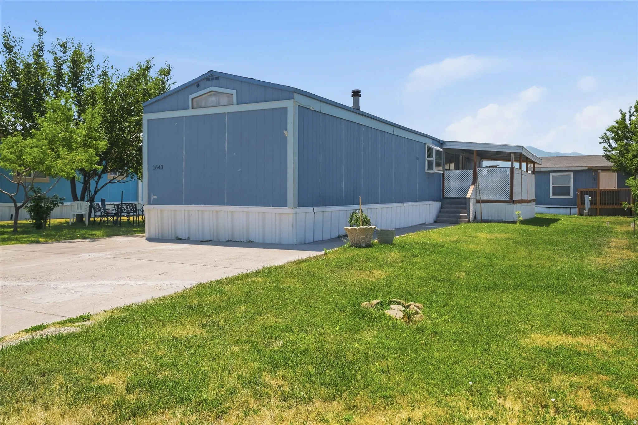 Blue siding exterior with a white perimeter foundation