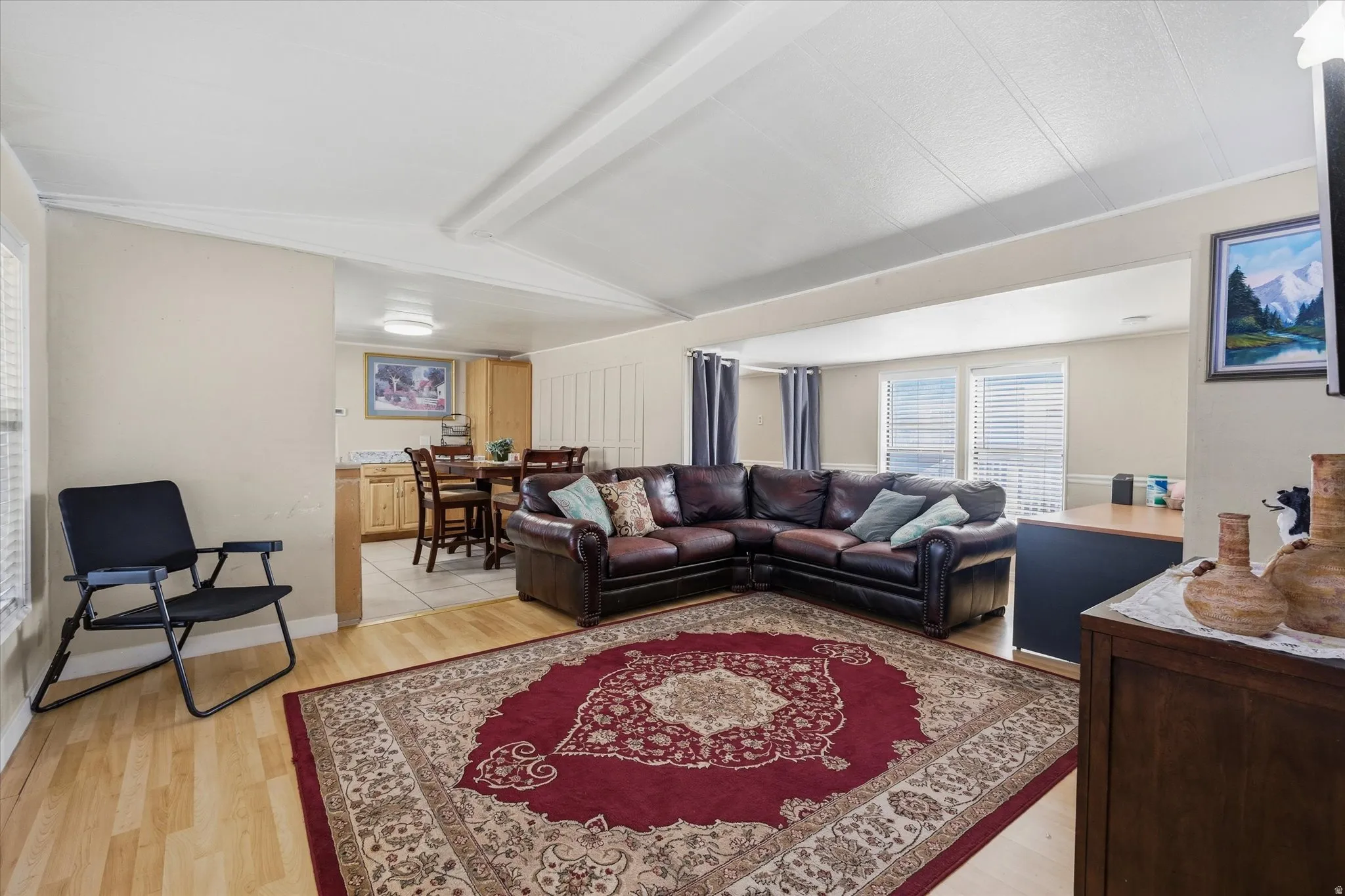 Open concept living area with wood-finish flooring