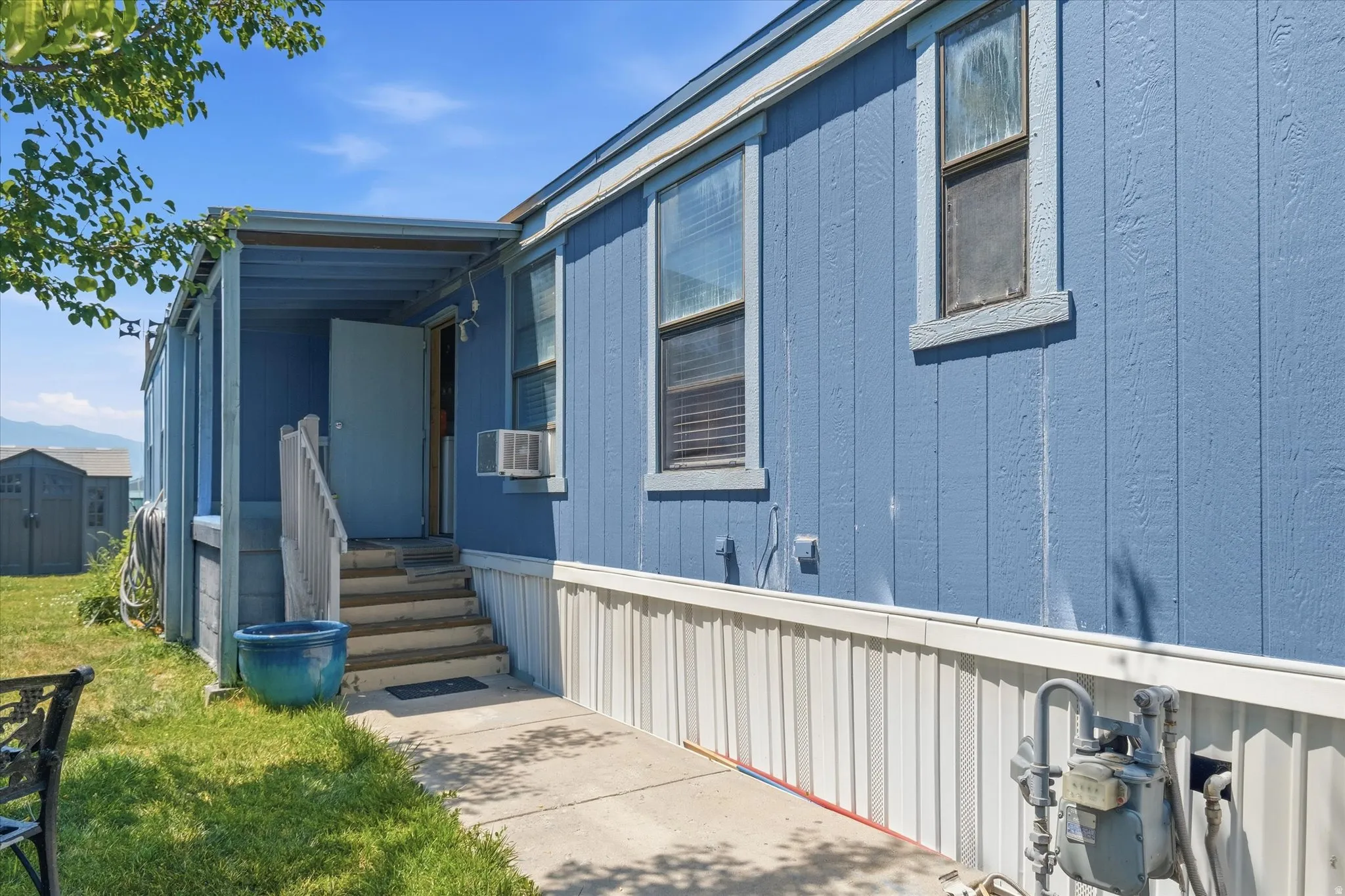 Blue exterior siding with white trim