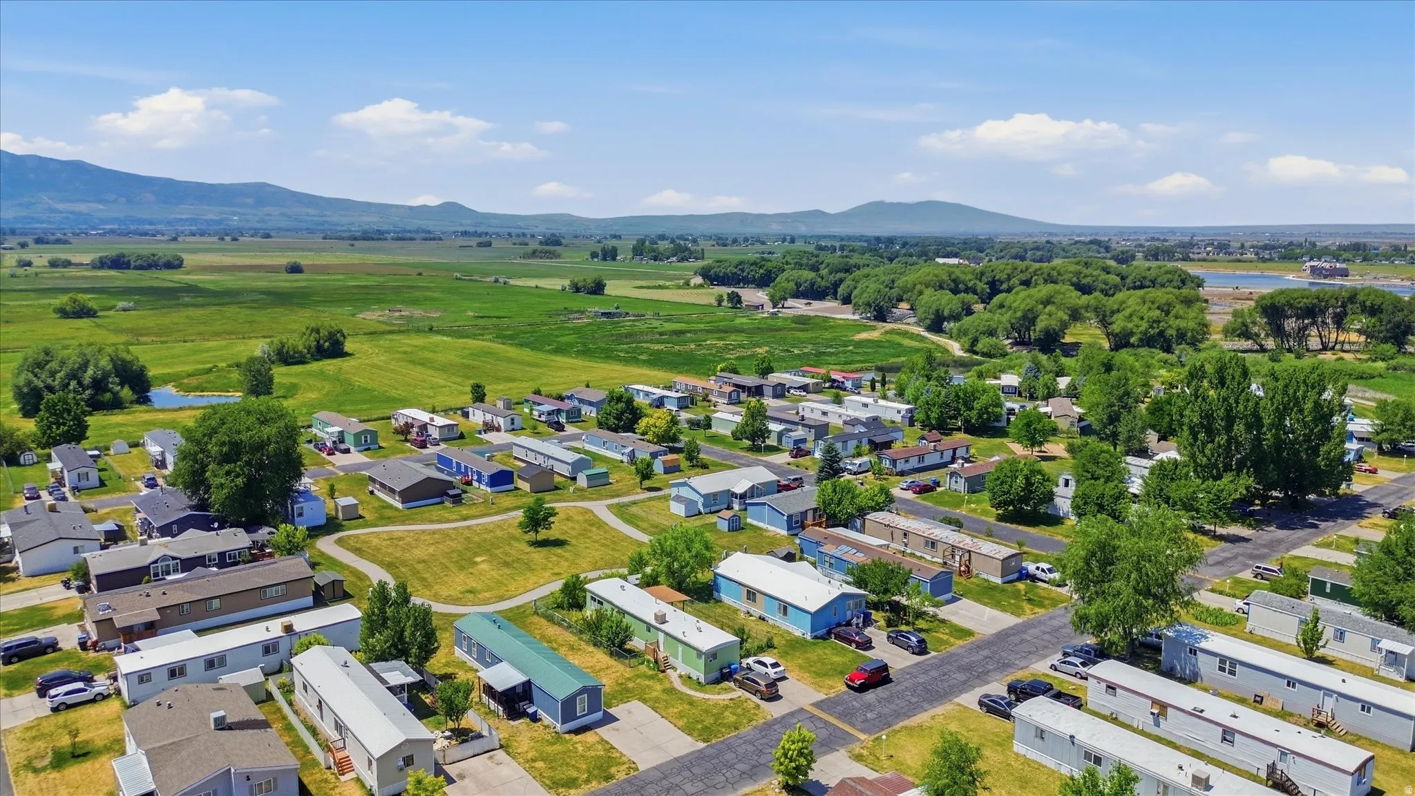 Expansive community with varied single-story residences, surrounded by abundant green space and mature trees