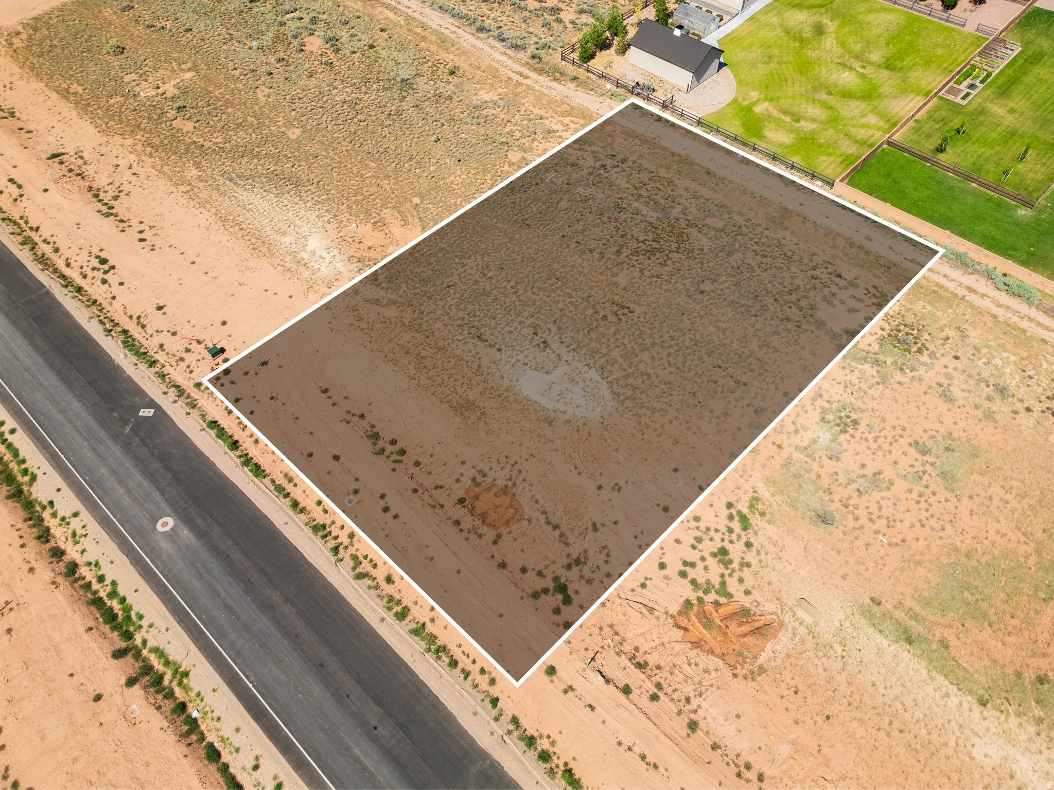 Expansive rectangular land parcel featuring desert landscaping