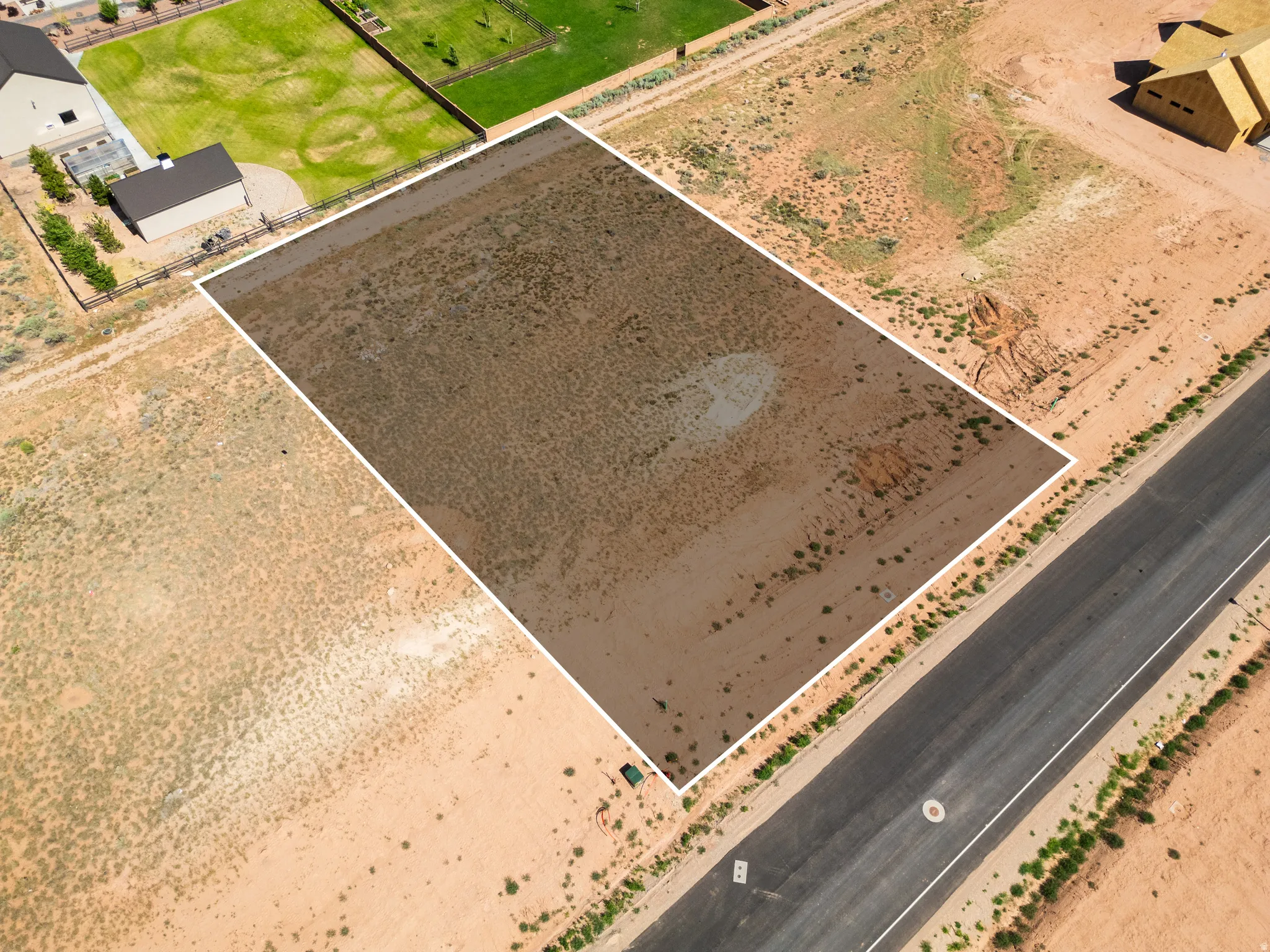 Spacious undeveloped lot featuring a rectangular shape, direct road frontage, and arid landscaping