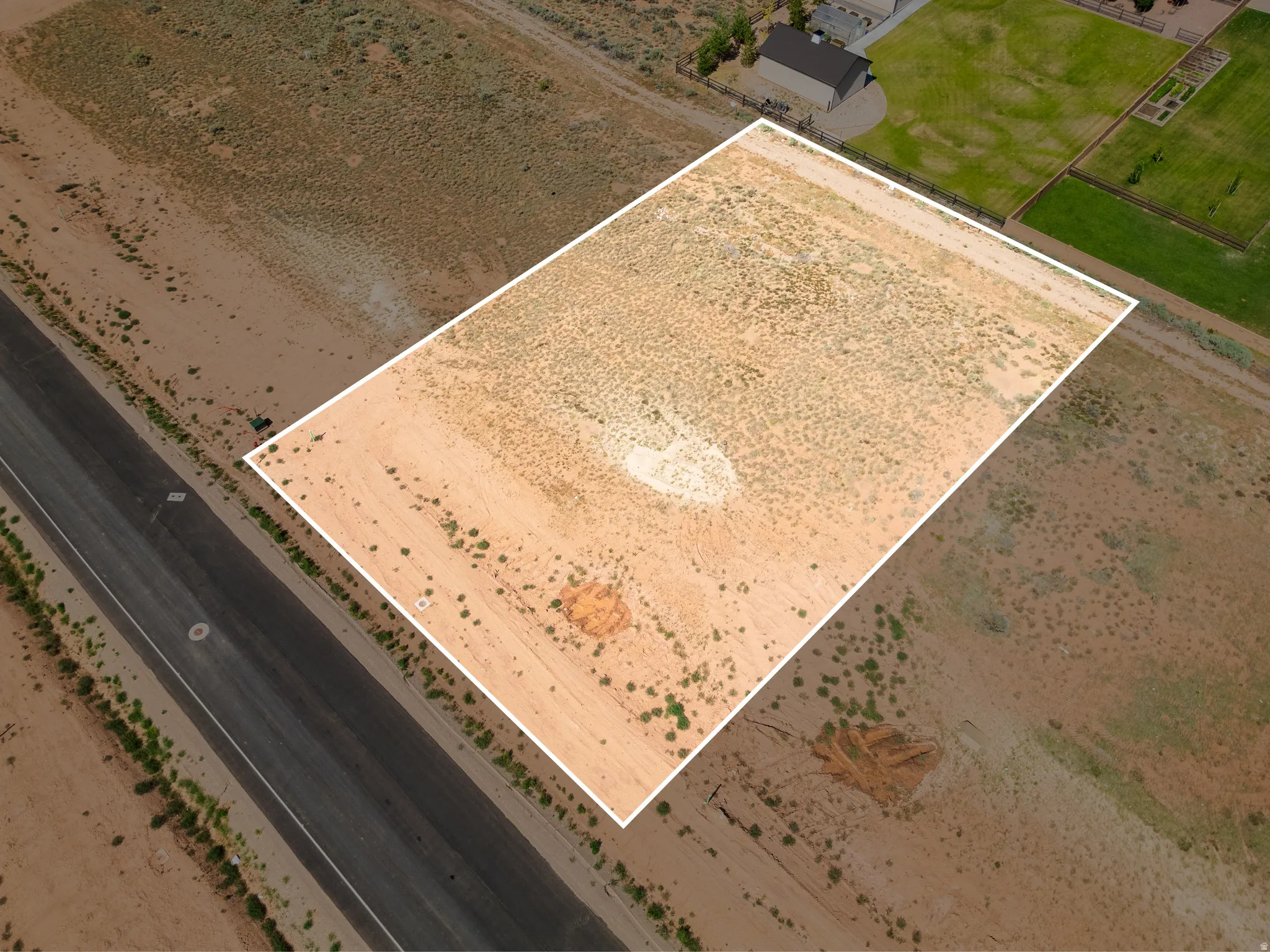 Expansive, unimproved desert lot with a distinct rectangular boundary