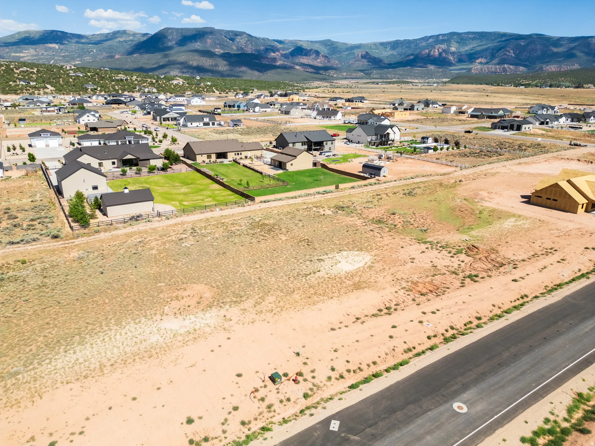 Expansive undeveloped lot with street access and surrounding residential properties