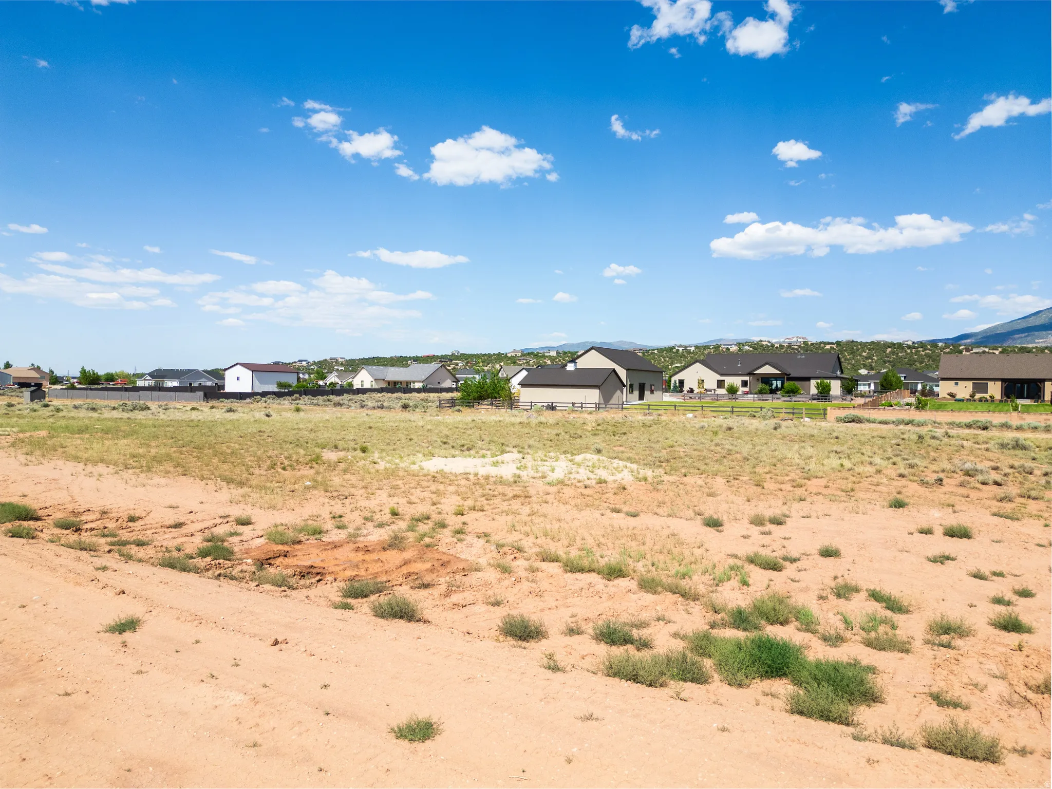 Expansive open land featuring natural desert vegetation