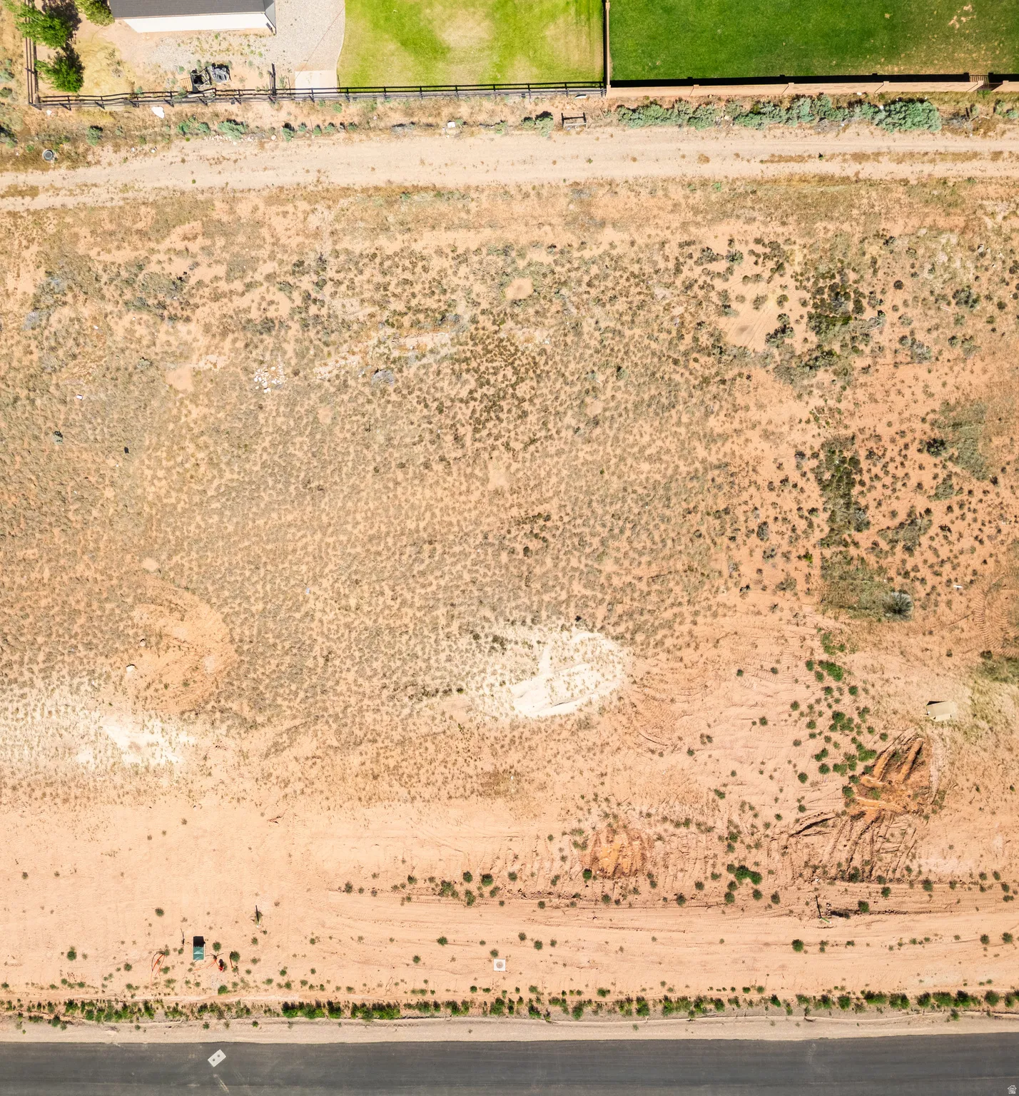 Expansive undeveloped land featuring a combination of natural vegetation and open earth
