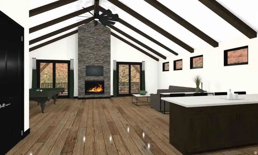 Vaulted ceilings with exposed dark wood beams complement the wood-finish flooring
