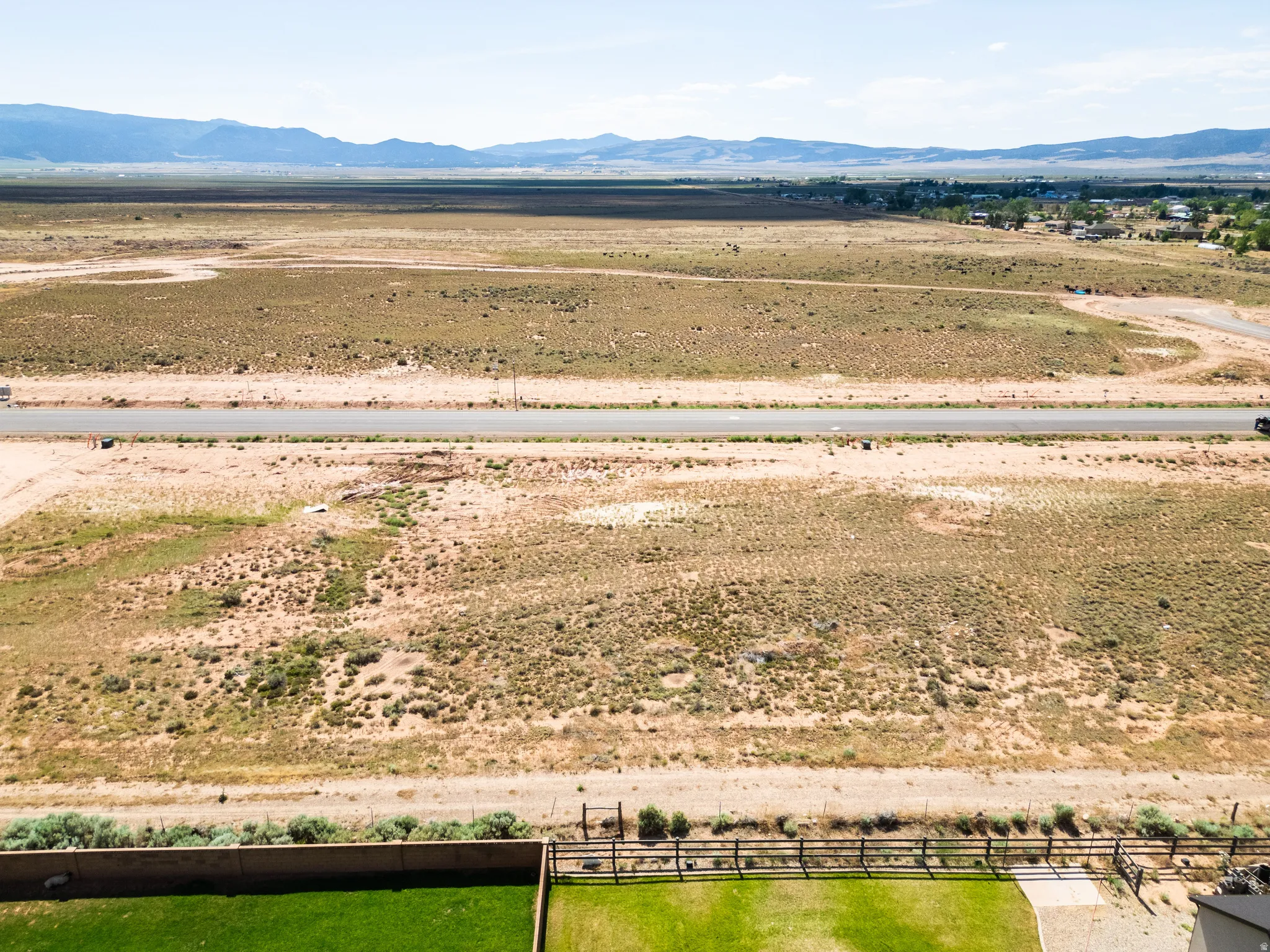 Expansive desert terrain with a paved road traversing the landscape
