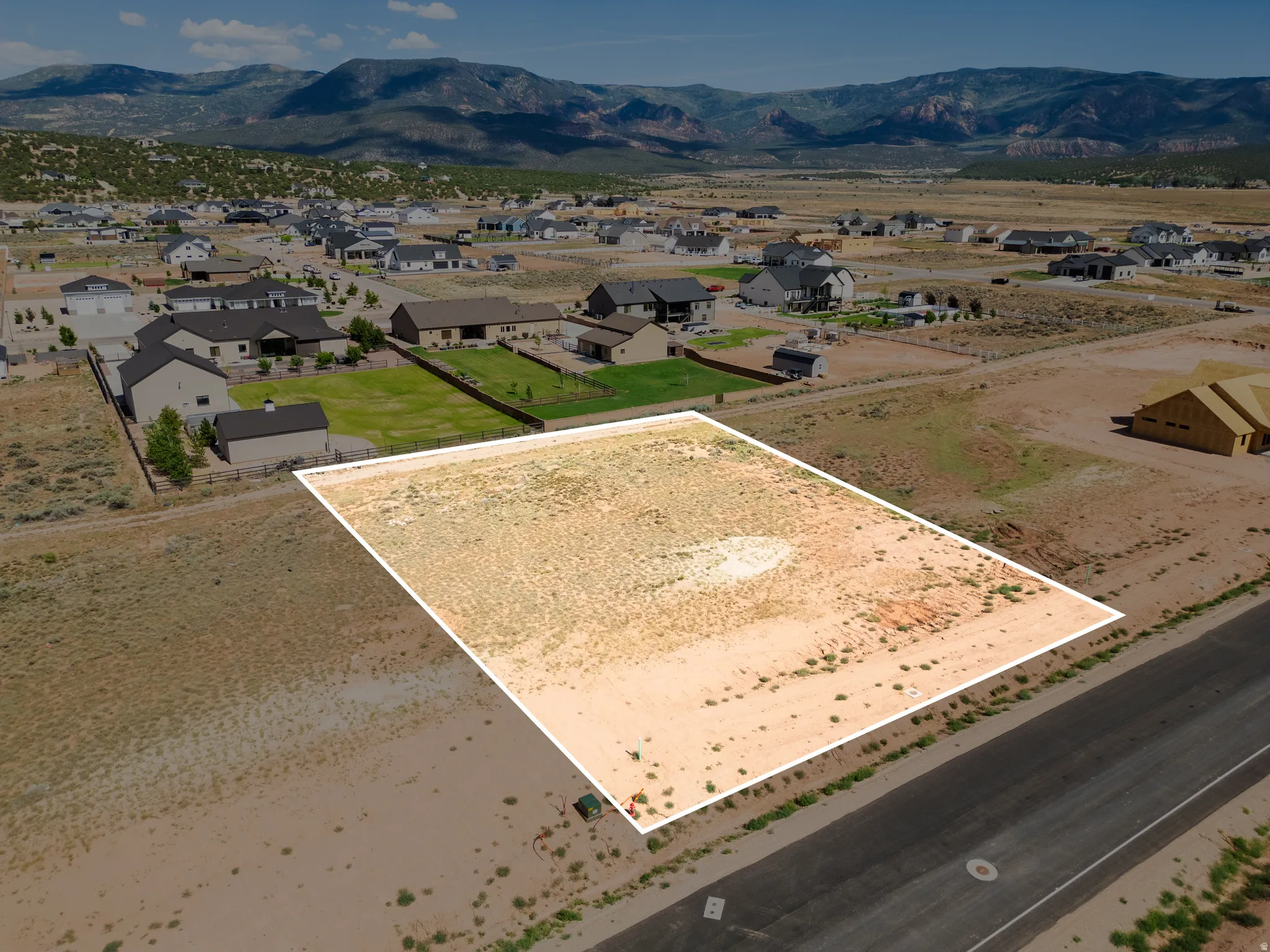 Expansive undeveloped lot with street frontage, bordered by established residential properties