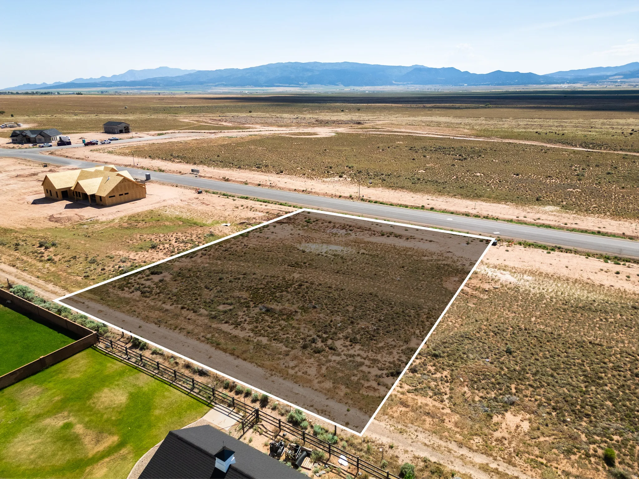 Expansive undeveloped lot featuring direct road frontage and distant mountain scenery
