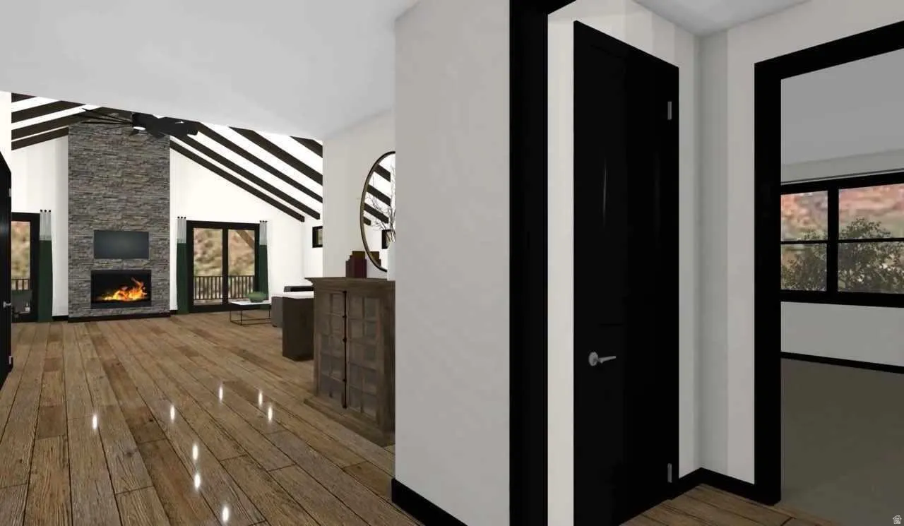 Spacious interior featuring wood-finish flooring and a vaulted ceiling with exposed beams