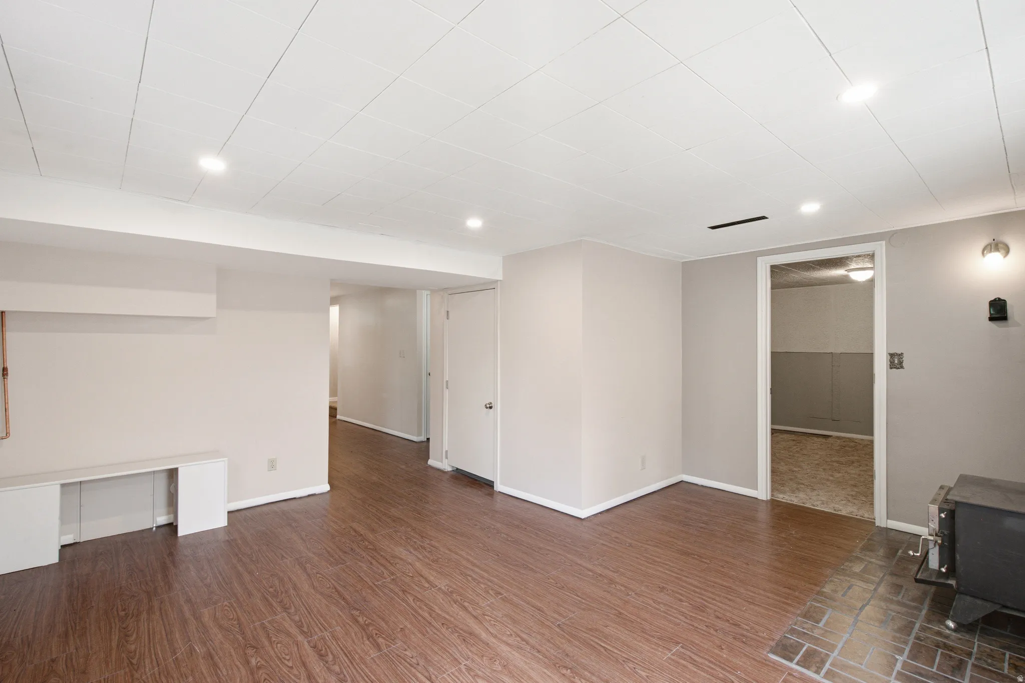 Spacious interior featuring wood-finish flooring, recessed ceiling lighting, and light neutral wall tones