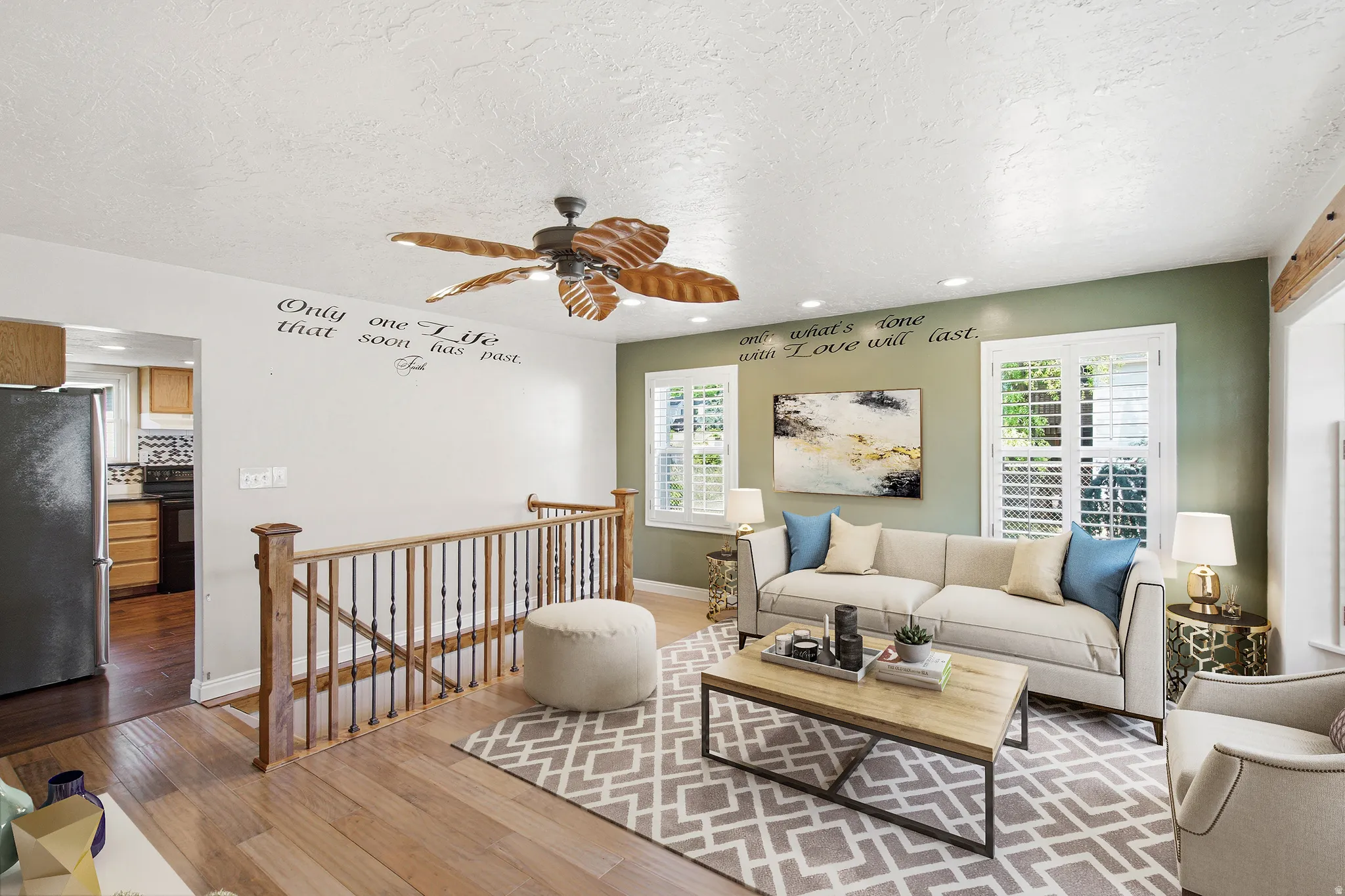 Living area featuring hardwood flooring, a ceiling fan, and white window shutters