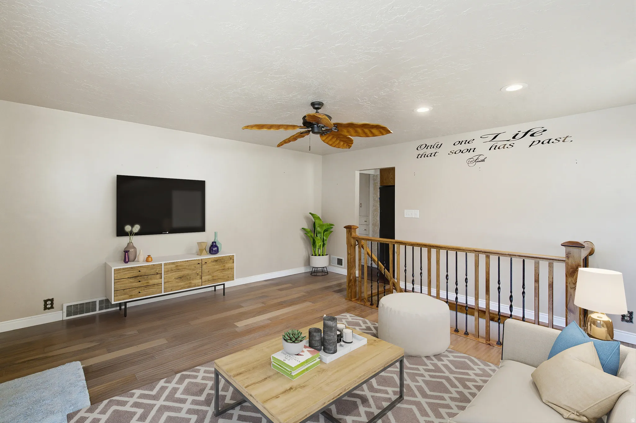 Open-concept living space featuring wood-finish flooring, a ceiling fan with wood-look blades, and recessed lighting
